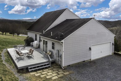 Side view with deck and garage opening