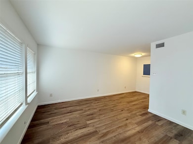 Empty room with wood finished floors and baseboar