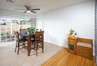 The dining room fittingly adjoins the kitchen and with its lighted ceiling fan, porcelain tiled floors and easy access to the backyard through the sliding glass doors and it is perfect for any occasion.