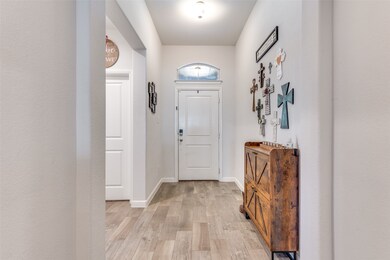 Entrance foyer featuring light wood finished floors and baseboards