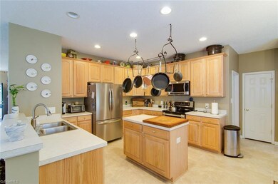 Kitchen features island and stainless steel appliances
