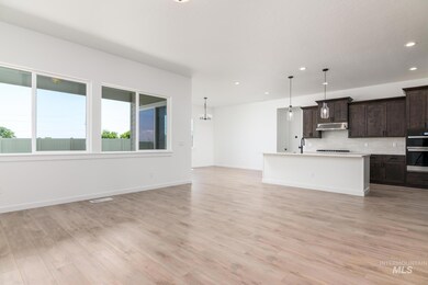 Unfurnished living room featuring recessed lighting, light wood finished floors, and a chandelier