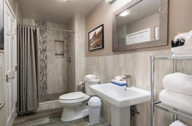 Full bathroom featuring a stall shower, wood finis