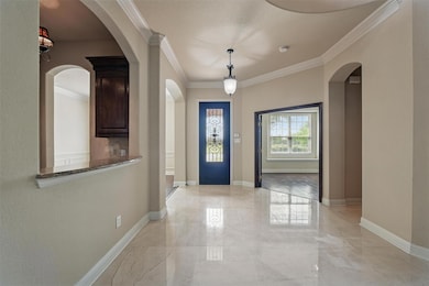 Foyer entrance featuring marble finish floor, base