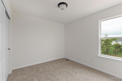Unfurnished room featuring baseboards and carpet