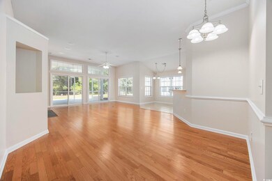 Empty room with ornamental molding, light hardwood