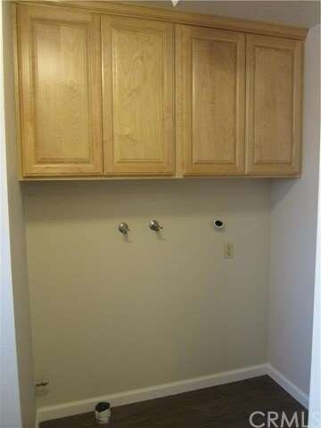 Inside laundry room with new maple cabinets.