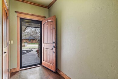 Foyer featuring a beautiful big wood front door an