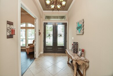 View of the french doors. Large tile throughout th
