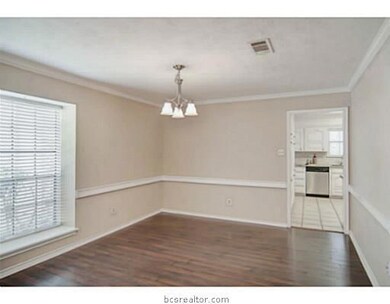 Dining Room. A sleek fixture, crown molding, chair