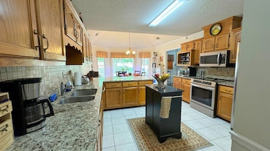 Kitchen featuring light tile patterned floors, sta
