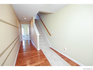 Entrance foyer features hardwood floors, recessed lighting, and custom paint.