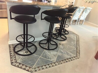 Tile inlay at breakfast bar separates the thick pa