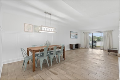 Dining room featuring a decorative wall and light wood-style floors