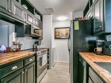 Kitchen featuring tasteful backsplash, light hardw