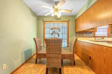 Dining space with ceiling fan, sink, a textured ce