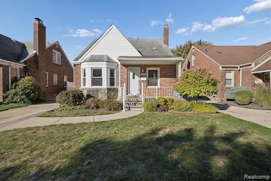 Bungalow-style home with a front lawn, brick siding, covered porch, and a chimney