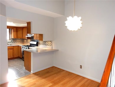 Kitchen is open to dining and features useful serv