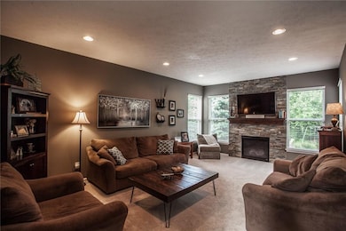 Inviting living room with gorgeous stacked stone feature wall and gas fireplace