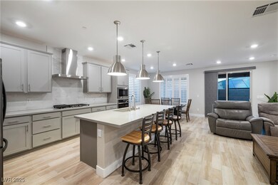 Kitchen featuring wall chimney exhaust hood, gray