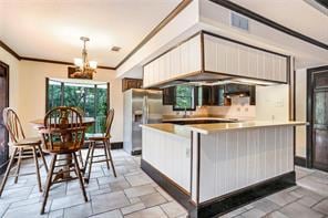 L-SHAPE ISLAND FEATURES CORIAN COUNTERS ROOM FOR SEVERAL CHAIRS, NOTE DOUBLE PANTRY TO RIGHT OF PHOTO.  EAT-IN BREAKFAST ROOM WITH GREAT WATER VIEWS AND WATCH THE WOOD DUCKS LAND IN THEIR HOUSES(THOSE WILL REMAIN)
