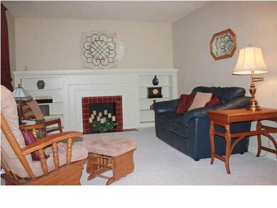 Living room with original fireplace (decorative).
