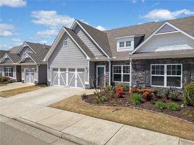Craftsman-style house with driveway, a garage, and
