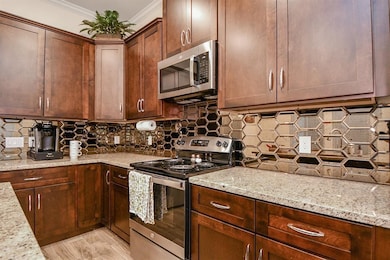 This kitchen features rich wooden cabinetry, sleek