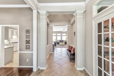 Upon entry you will be amazed at the beautiful architectural touches. The large private office is through the french doors to the right and the formal dining room, which may be used as another office, is to the left. Both the office and the dining room are adorned with luxurious wood floors.