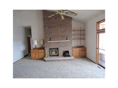 Great Room. Brick woodburning fireplace, bookcases