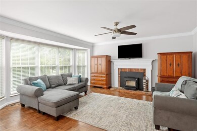 Sunny family room w wood burning fireplace.