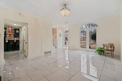 Living room/ entry with ornamental molding, a chan