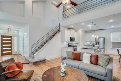 Living room featuring light wood-style floors, ce