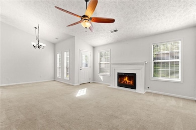 Living room with baseboards, a textured ceiling, a