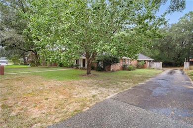 View of yard with asphalt driveway