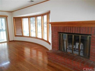 Living room with hardwood floors and tinted bowed 