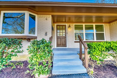 Doorway to property featuring brick siding