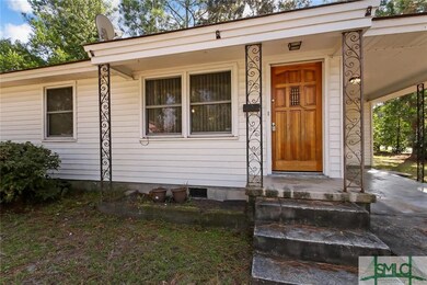 Iron railings adorn this covered front stoop.