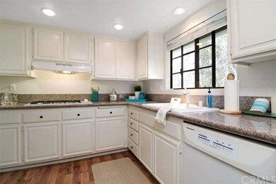 Light and bright kitchen looks out to front greenb