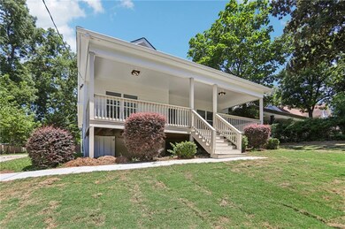View of front of home featuring a front lawn and covered porch