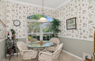 Dining area featuring crown molding and light tile