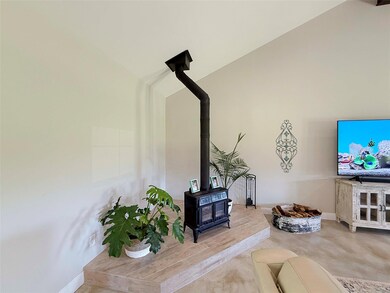Living area with a wood stove and baseboards