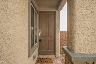 View of exterior entry featuring stucco siding