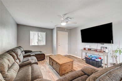 Living area with light wood-type flooring and ceil