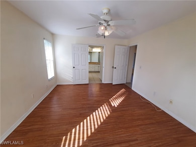 Spare room featuring ceiling fan, baseboards, and