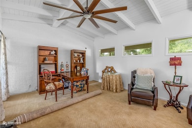 Living area with carpet flooring, ceiling fan, and wood ceiling