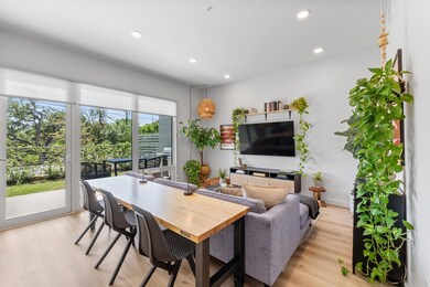 Living room with recessed lighting and light wood