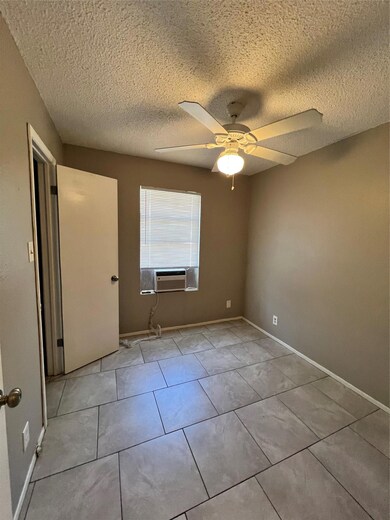 Unfurnished bedroom with light tile patterned flo