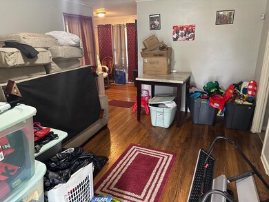 Bedroom featuring crown molding and wood-type floo