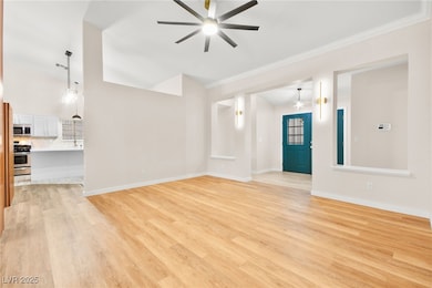 Unfurnished living room with ceiling fan, crown mo